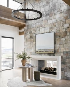 a living room with a stone wall and fireplace