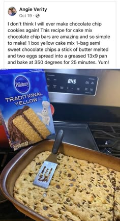 a pan filled with cake next to a box of chocolate chip cookies and a spatula