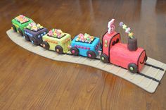 a cake shaped like a train on a wooden table