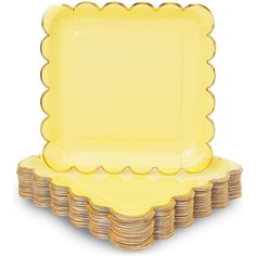 a stack of yellow plates with scalloped edges on each plate, set against a white background