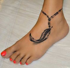 a woman's foot with a feather tattoo on it