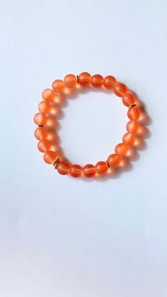 This listing is for 1 bracelet Made with 8mm matte glass beads in orange and gold plated spacer beads.. The beads are strung on a durable, stretchy cord so they are easy and comfortable to wear.  Mix+match your bracelets to create your own style! Orange Stretch Bracelet With Large Beads As Gift, Adjustable Orange Beaded Bracelets With 8mm Beads, Gift Orange Stretch Bracelet With Large Beads, Orange Beaded Bracelets With 8mm Round Beads, Handmade Orange Stretch Bracelet, Adjustable Orange Stretch Bracelet With 8mm Beads, Orange Stretch Bracelet With 8mm Beads, Orange Faceted Beaded Bracelets, Orange Bracelets With 8mm Round Beads