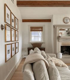 a living room filled with furniture and a fire place next to a wall mounted clock