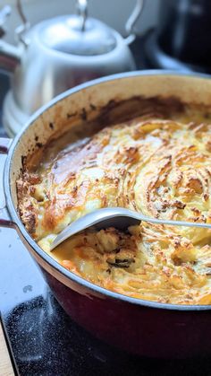 a casserole dish with a spoon in it