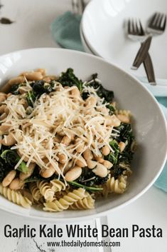 a white bowl filled with pasta and greens