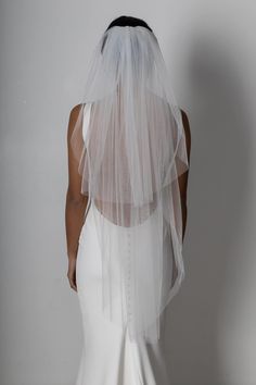 the back of a woman wearing a wedding veil