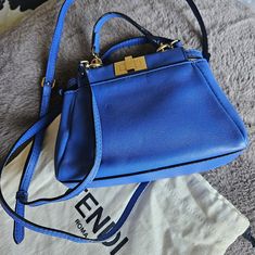 100% Authentic Guaranteed Beautiful Fendi Mini Peekaboo Blue Bag It's Pretty Cute And Good Condition Yes Has Some Minor Signs Of Wear Dent And Minor Cracks On The Handle Clean In And Out, Corners Are Great Sling And Dustbag Are Included Peekaboo Mini Fendi, Fendi Mini, Pretty And Cute, Fendi Bags, Blue Bags, Mini Bag, Dust Bag, Fendi, Bag Lady