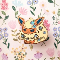 a pin with an image of a small animal on it's back and flowers in the background