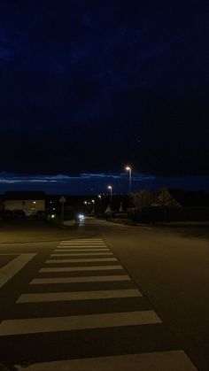 an empty street at night with the lights on