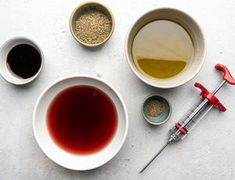 an overhead view of various bowls and spoons filled with liquid