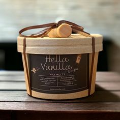 a jar of vanilla wax sitting on top of a wooden table