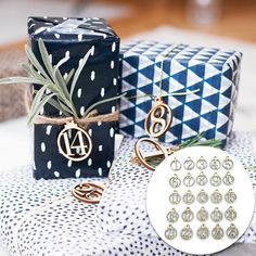 two wrapped presents with monogrammed designs and an air plant are on the table next to each other