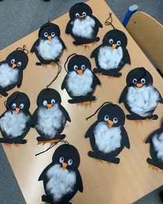 a bunch of penguins that are sitting on a table