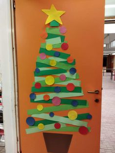 a christmas tree made out of construction paper on the door to a school classroom room