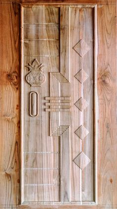 the door is made out of wood and has designs on it