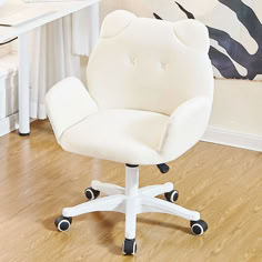 a white office chair sitting on top of a hard wood floor