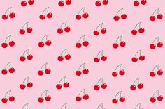 a pink background with cherries on it