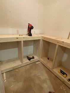 a room that is being remodeled with tools on the floor and cabinets in front of it