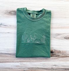 Cactus Comfort Colors Tee, Plant Shirt, Desert T-shirt, Embroidered Tee, Embroidered Shirt, Custom Shirt, Plant Lady Shirt, Western Tee - Etsy Green Crew Neck T-shirt With Custom Embroidery, Green Cotton Top With Embroidered Graphics, Green Relaxed Fit Top With Embroidered Logo, Relaxed Fit Green Top With Embroidered Logo, Green Cotton Shirt With Floral Embroidery, Green Long Sleeve T-shirt With Custom Embroidery, Green Embroidered Cotton Shirt, Embroidered Green Cotton Shirt, Cotton Tops With Machine Embroidery And Relaxed Fit