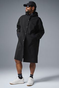 Stay dry without compromising style in this coat. It's stacked with functional features like a tall collar, a hood with bungees, zippered side pockets, and a secure zipper-and-snap front. Plus, it's made from soft, lightweight, 100 percent waterproof ripstop with a relaxed fit to accommodate movement. Cool on the streets? Yes. Suitable for stormy days? Also yes. Alo Yoga Hooded Outerwear With Drawstring, Modern Oversized Outerwear With Detachable Hood, Black Hooded Raincoat For Work, Techwear Outerwear With Detachable Hood For Work, Alo Yoga Fall Outerwear With Drawstring Hood, Alo Yoga Outerwear With Drawstring Hood For Fall, Alo Yoga Drawstring Hood Outerwear For Fall, Modern Black Parka With Detachable Hood, Casual Black Alo Yoga Outerwear