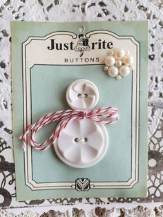 a white button with red and white string attached to it