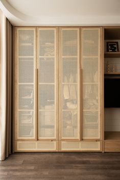 an empty room with wooden paneled doors and shelves on either side of the wall