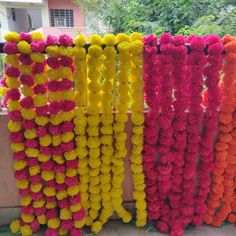 colorful garlands hanging on the side of a building