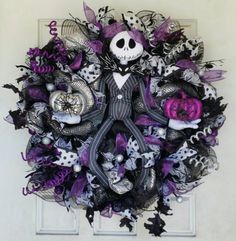 a purple and black wreath with a skeleton on it