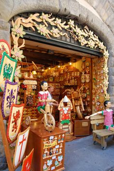 a store front with wooden decorations and figurines on display