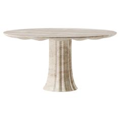 a white marble table with an oval top and pedestal base, on a white background