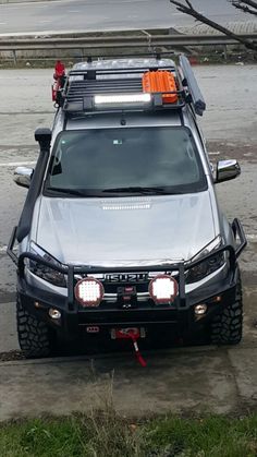 an suv parked in a parking lot with its lights on