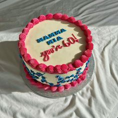 a pink and blue birthday cake with the words mama mia you're 60 on it