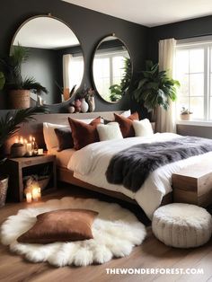 a large bed sitting in a bedroom next to two round mirrors and candles on the wall