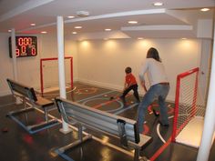 two people are playing basketball in an indoor court with goal posts and benches on the floor