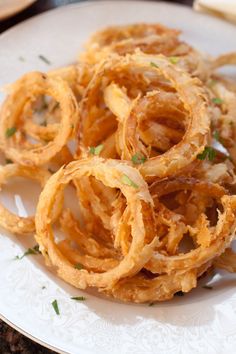 some onion rings are on a white plate