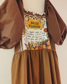 the dress is brown and has flowers on it