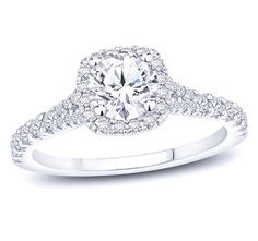 a white gold engagement ring with an oval diamond center and pave set diamonds around the band