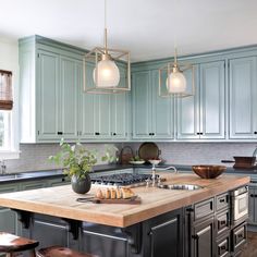 a kitchen island with two lights hanging over it