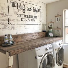 a washer and dryer are sitting in front of a sign that says, the fluffy and fold co