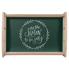 a green tray with the words in the season to be jolly written on it