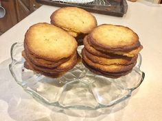 some cookies are stacked on top of each other in a glass dish, ready to be eaten