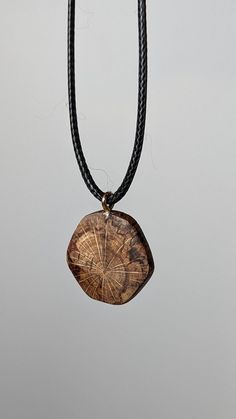 This is a handcrafted wooden pendant made from locally sourced and naturally fallen wood. This pendant features a beautiful and unique pattern caused by the natural decay of wood, as well as a hand sculpted design as a juxtaposition to the organic shapes of the spalting. The result is a timeless, breathtaking and organic piece of jewelry that suits women, men and children for almost any occasion or simply everyday life. I make these using only naturally fallen wood that I find on walks through m Carved Natural Wood Necklaces, Natural Carved Nature-inspired Necklace, Artisan Natural Wood Pendant Necklace, Nature-inspired Carved Natural Necklace, Natural Wood Pendant Necklace, Rustic Natural Wood Necklace, Sliding Knot, Wooden Pendant, Handmade Necklace