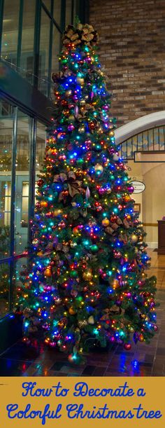 a brightly lit christmas tree in front of a brick building with the words houston decorates a colorful christmas tree