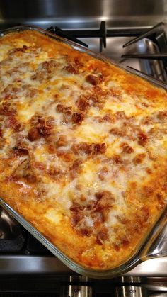 a cheesy casserole is sitting on top of the stove and ready to be eaten