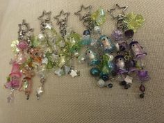 many different colored beads and charms on a white surface with a star shaped object in the middle