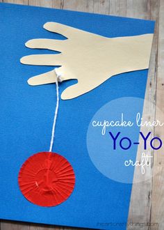 an image of a hand holding a red paper circle with the words yo yo on it