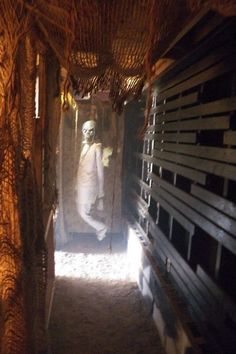 a man standing in the doorway of a building