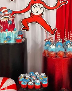 the cat in the hat birthday party with cake, candy and cupcakes on display