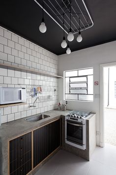 a kitchen with an oven, sink and microwave