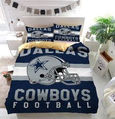 a bed room with a football themed comforter and pillows